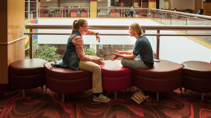 Two students sitting and talking in Plaster Student Union