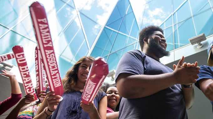 Line of students holding cheering props