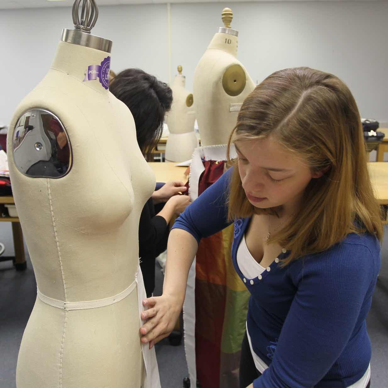 Student fitting fabric on a fashion mannequin