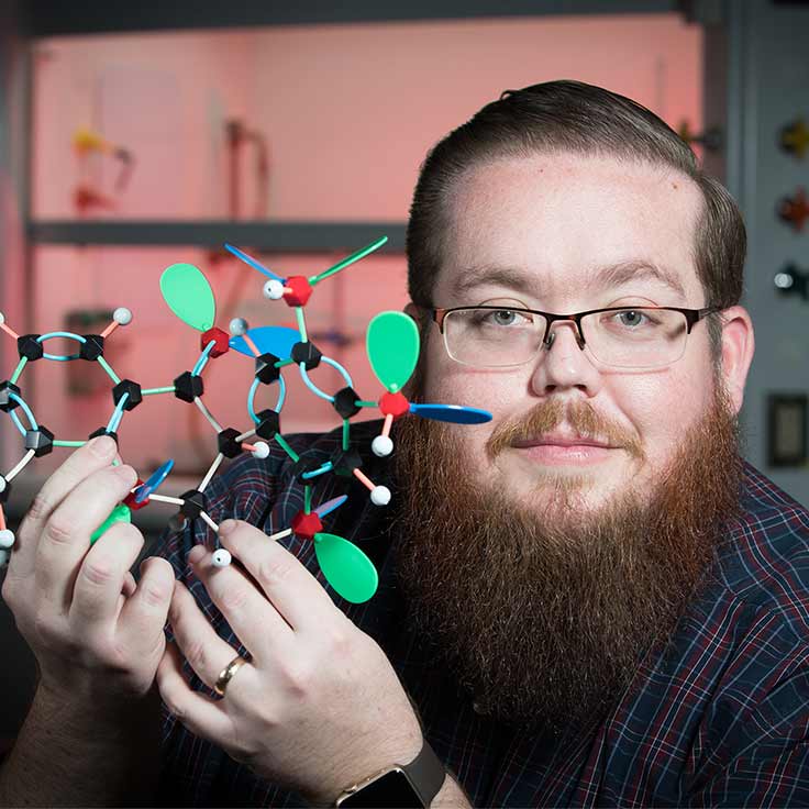 Dr. Matt Siebert holding a molecule