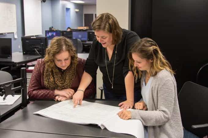 Faculty member reviewing project with two students